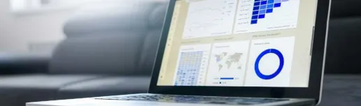 A laptop showing a set of charts on the screen